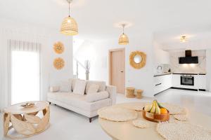 a white living room with a white couch and a table at Lambda Luxury Villa 1 in Syvota