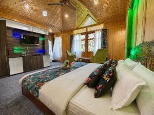 a bedroom with a large bed and a tv at The Heritage Group of Houseboats in Srinagar