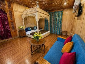 a bedroom with a bed and a couch and a table at The Heritage Group of Houseboats in Srinagar +24 photos