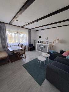 a living room with a couch and a table at Ferienwohnung Natalia in Thalfang