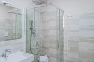 a bathroom with a glass shower and a toilet at Le Suite in Crotone +15 photos