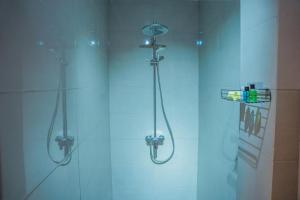 a shower with a glass door with a shower at Villa Oceana By Heritage in Hikkaduwa +68 photos