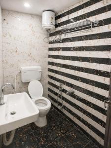 a bathroom with a toilet and a sink at Paavan Palace in Ayodhya