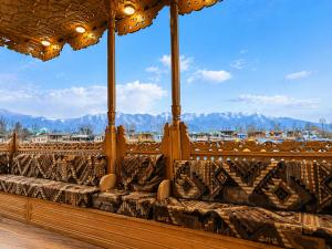 a row of benches with mountains in the background at The Heritage Group of Houseboats in Srinagar