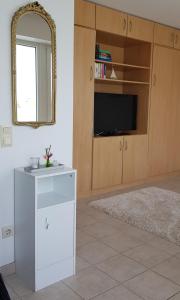a living room with a white dresser and a mirror at Alte Teestube Alte Teestube 14 in Norderney