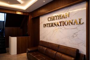 a lobby with a sign that reads cheetah international at Chethan International in Bangalore