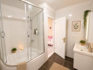 a white bathroom with a shower and a sink at Begonville Villas Ladies Beach in Kuşadası