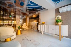a lobby with a reception desk and chairs at Noble Hotel by Building Stefan in Mamaia Sat/Năvodari