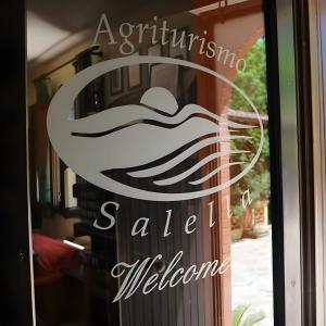 a sign in the window of a store at Agriturismo Salella in Salento