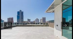 a balcony with a view of a city skyline at Studio Centro Curitiba - para ate 3 pessoad in Curitiba