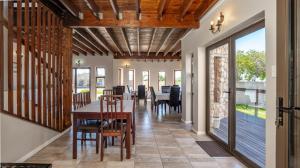 a dining room with a table and chairs at Stonehouse on Main in Struisbaai