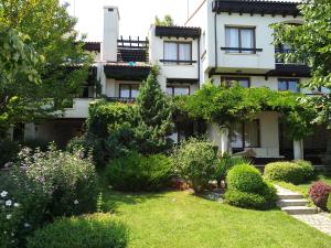 an apartment building with a garden in front of it at Oasis Resort&Spa Lozenets Studio 12 in Lozenets