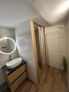 a bathroom with a sink and a mirror at Apartment nad Metují in Teplice nad Metují +64 photos