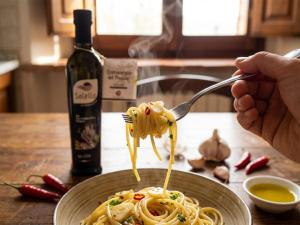 a person eating pasta on a fork with a plate at Agriturismo Salella in Salento