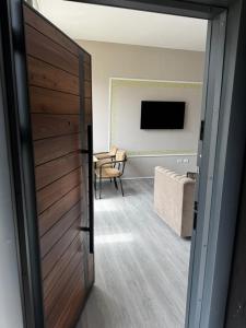 a room with a sliding door with a living room at Forum View Apartments in Durrës +8 photos