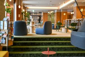a lobby of a store with chairs and tables at Hotel Edel Warme in Furano