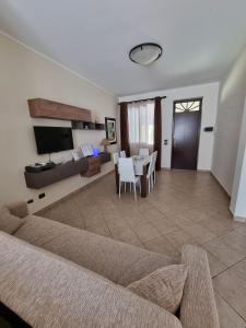 a living room with a couch and a table at Villa Sunshine in Balestrate