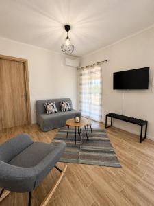 a living room with a couch and a table at Casa Plati 2 - Peaceful Garden Stay with Pool in Platí