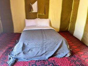 a bed sitting inside of a tent at Sahara Standard Camp in Merzouga