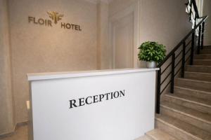 a reception counter with a potted plant on it at Shkoder City Center - Floir Hotel in Shkodër +37 photos