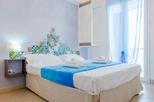 a bedroom with a christmas tree and a bed at Sterlizia Rooms in Gallipoli