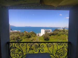 a view of the ocean from a balcony at Pinwheel Hostel Vlora & Rooftop Bar in Vlorë