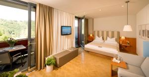 a hotel room with a bed and a desk at Schloss Seggau in Leibnitz +63 photos