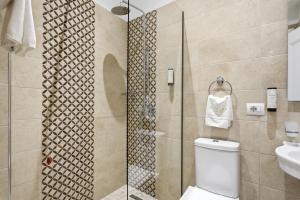 a bathroom with a shower with a toilet and a sink at Hotel Giulia in Durrës +50 photos