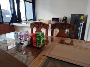 a kitchen with two chairs and a glass table at Casa San Rafael in Oaxaca City