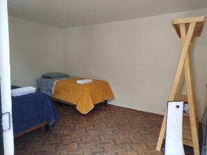 a small room with two beds and a ladder at Casa San Rafael in Oaxaca City