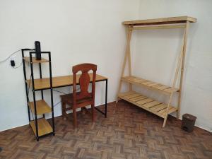 a room with a desk and a chair and shelves at Casa San Rafael in Oaxaca City +7 photos