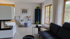 a living room with a couch and a tv at Ferienhaus Mind-Storm in Rimsting +17 photos