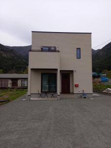 a large white building with a large door at ミエル富士 in Oishi