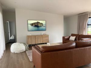 a living room with a couch and a table at The Batch in Oamaru