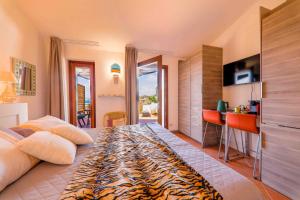 a bedroom with a king sized bed and a kitchen at B&B Les Capitaineries in Bonifacio
