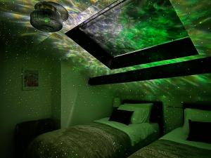 a bedroom with a green wall with a starry ceiling at The Joseph Cosy at Lancaster in Lancaster +121 photos