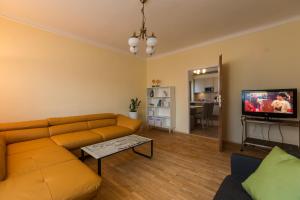 a living room with a couch and a tv at Haus Helene in Mörbisch am See