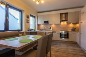 a kitchen and dining room with a wooden table at Haus Helene in Mörbisch am See