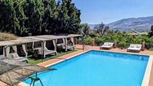 a swimming pool with chairs and a gazebo at La Cañota King Rooms Adults Only in Talara