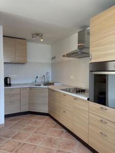 a large kitchen with wooden cabinets and stainless steel appliances at Central nude oasis in Makarska