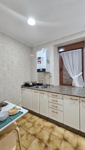 a kitchen with white cabinets and a counter top at 2 Hermanas in Cudillero