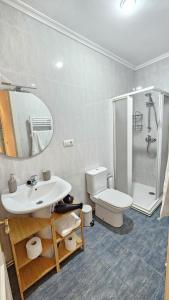 a bathroom with a sink and a toilet and a shower at 2 Hermanas in Cudillero +18 photos