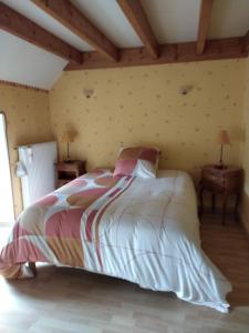 a bedroom with a bed and two night tables at Le fourezon in Saint-Jeures