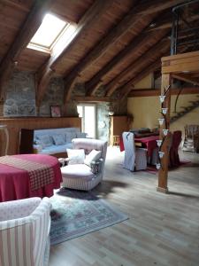 a living room with white chairs and tables in a building at Le fourezon in Saint-Jeures