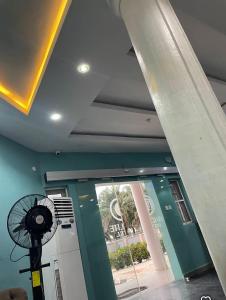 a building with a ceiling fan and a window at Davic-lite hotel and suites in Okitipupa