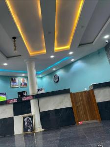 a hotel lobby with blue lighting and a counter at Davic-lite hotel and suites in Okitipupa