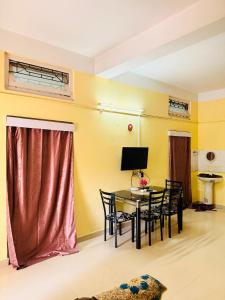 a dining room with a table and chairs at Moon Villa Homestay in Nowgong