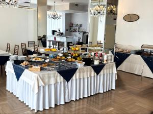 a table with a buffet of food on it at Hotel Degli Angeli Riccione in Riccione