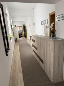 a hallway with a reception desk in a room at Gile Guest House in Veliko Tŭrnovo