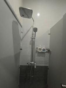 a bathroom with a shower with a shower head at Gia An Hotel in Hanoi